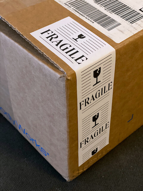 "Fragile" moving sticker on a cardboard box