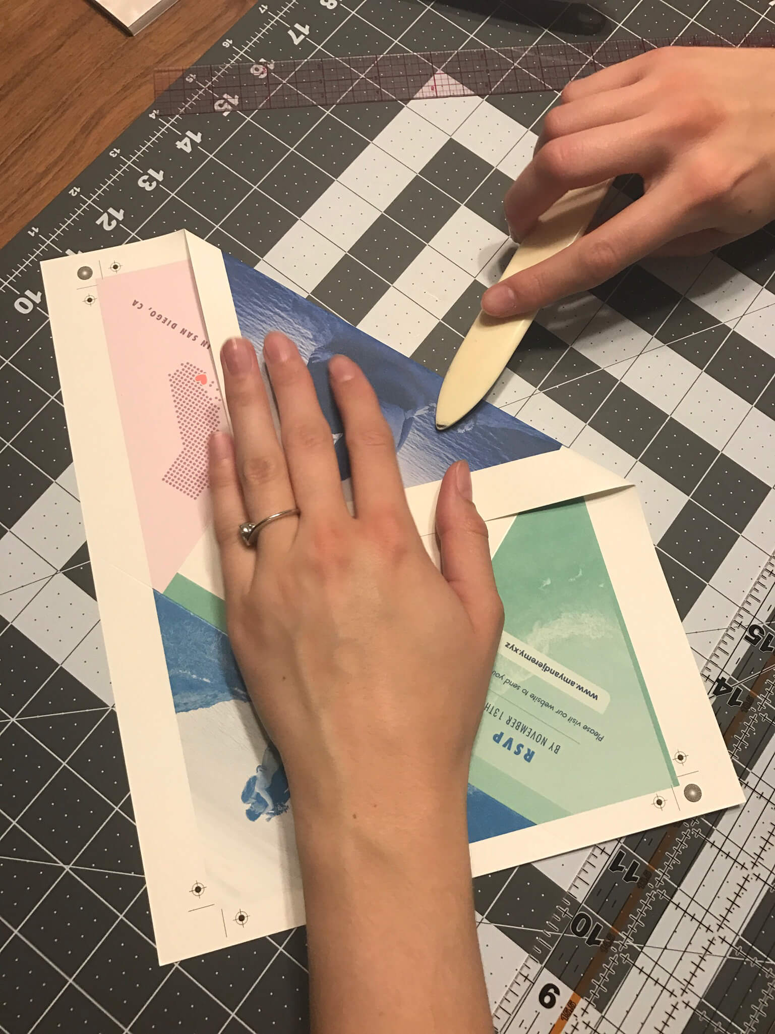 Photo of the process of scoring and folding Amy's wedding invitations